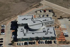 Ennis Business Forms with a flat roof, installed by Alpine Roofing Construction