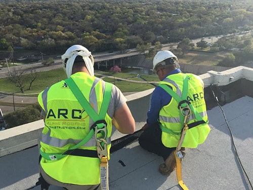 Two team members of Alpine Roofing Construction at work